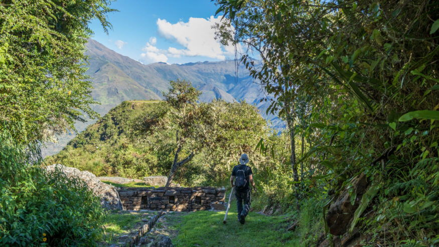 Young tourist with backpack hiking at high altitude Peruvian mountains, the Choquequirao trek to Machu Picchu, alternative to Inca Trail, Peru